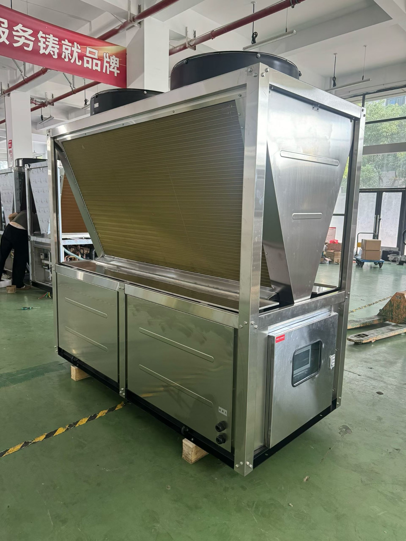Side view of a stainless-steel industrial heat pump unit