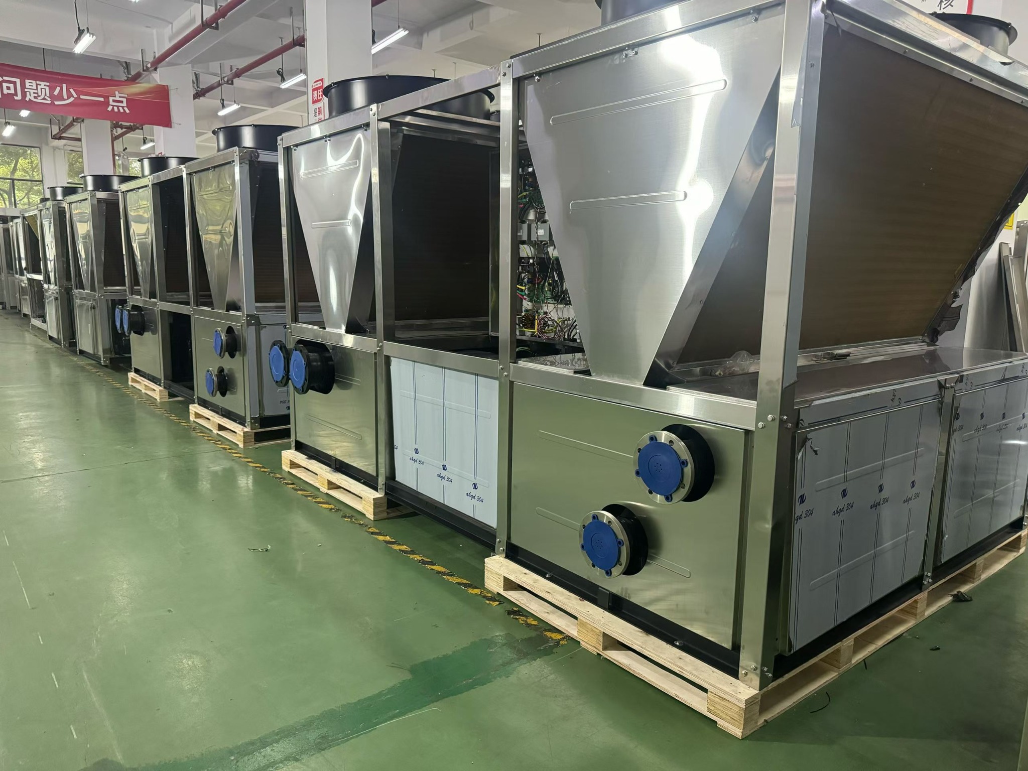 Industrial heat pump units lined up in a production area